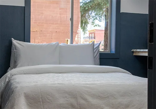 Room with two queen beds and a window overlooking Blair Street at Kendall Mountain Lodge